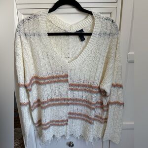 Light distressed sweater. Super comfortable. Only worn a few times. Like new.